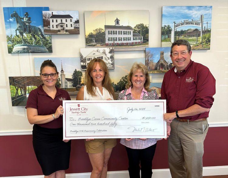 Pictured are representatives of the Brooklyn Cares Community Center receiving a donation from Jewett City Savings Bank's Brooklyn Branch Manager and President and CEO.