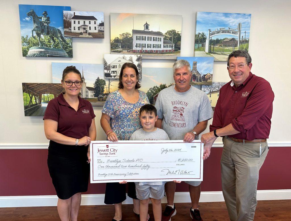 Pictured are representatives of the Brooklyn Schools PTO receiving a donation from Jewett City Savings Bank's Brooklyn Branch Manager and President and CEO.